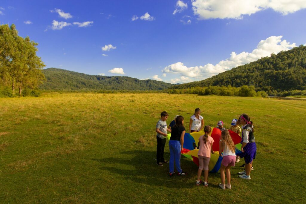 group of people standing on green grass field during daytime