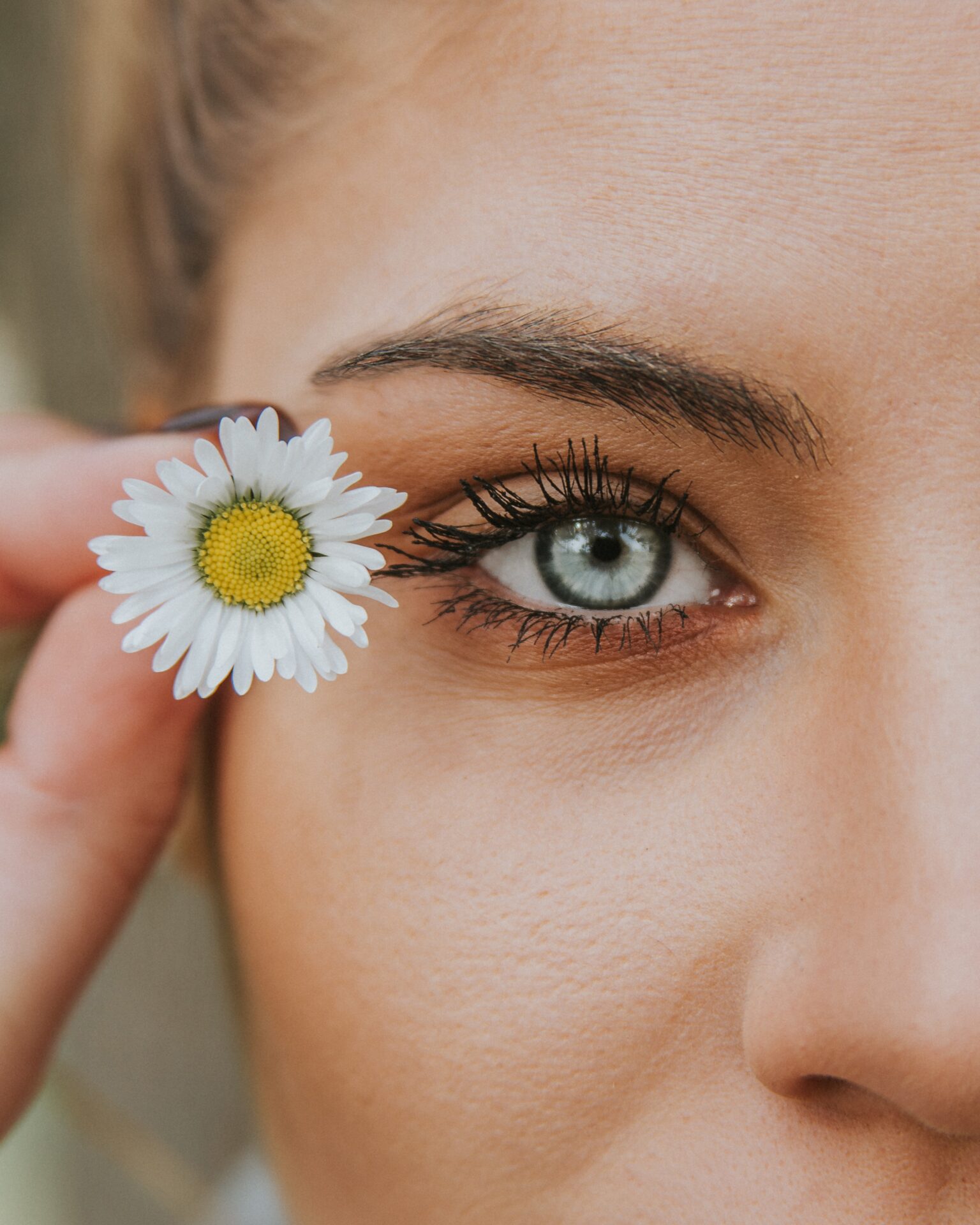 white petaled flower near woman eye