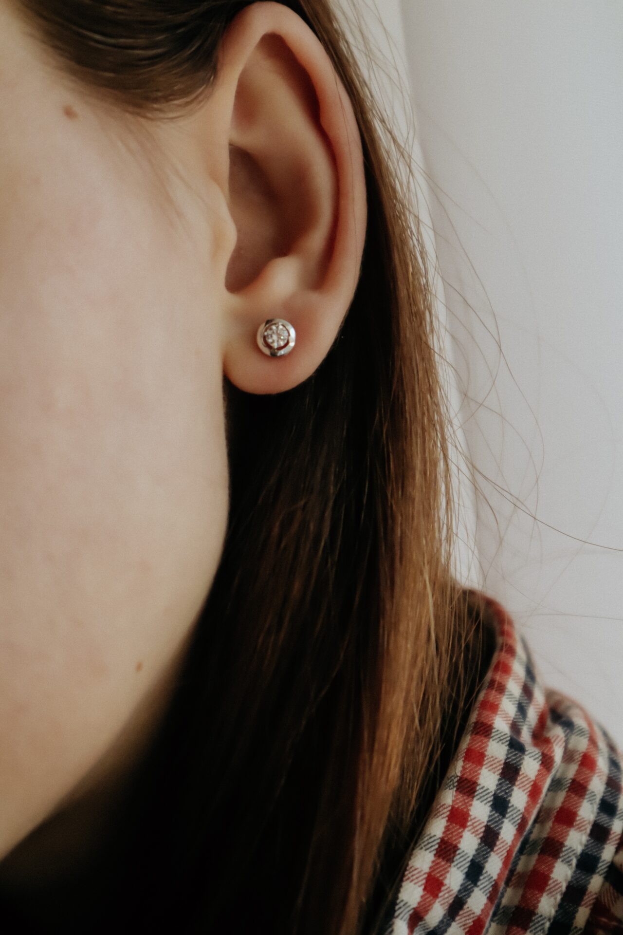 woman wearing silver stud earring