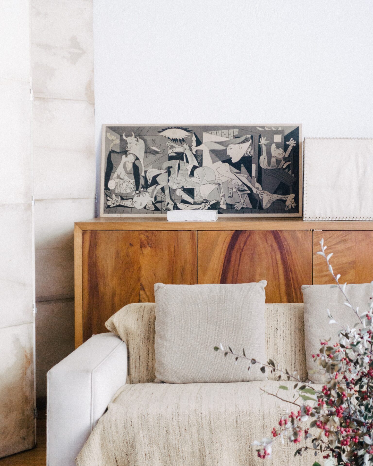 brown wooden sideboard beside beige fabric sofa