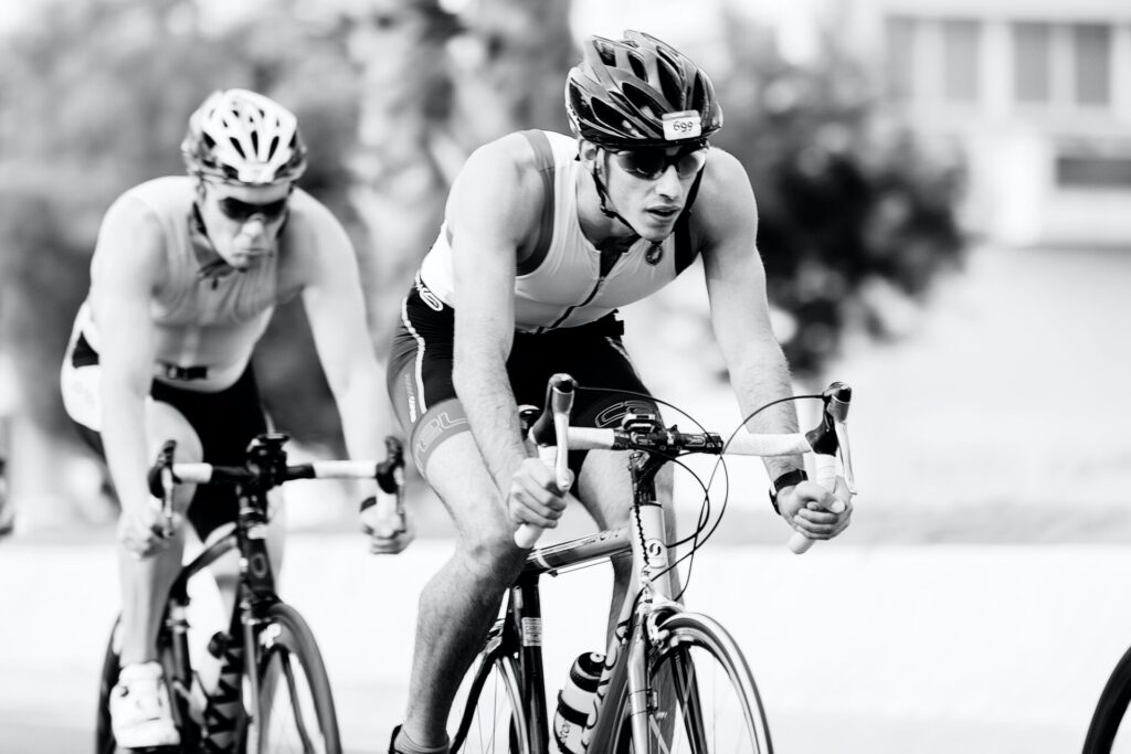 two men riding road bike